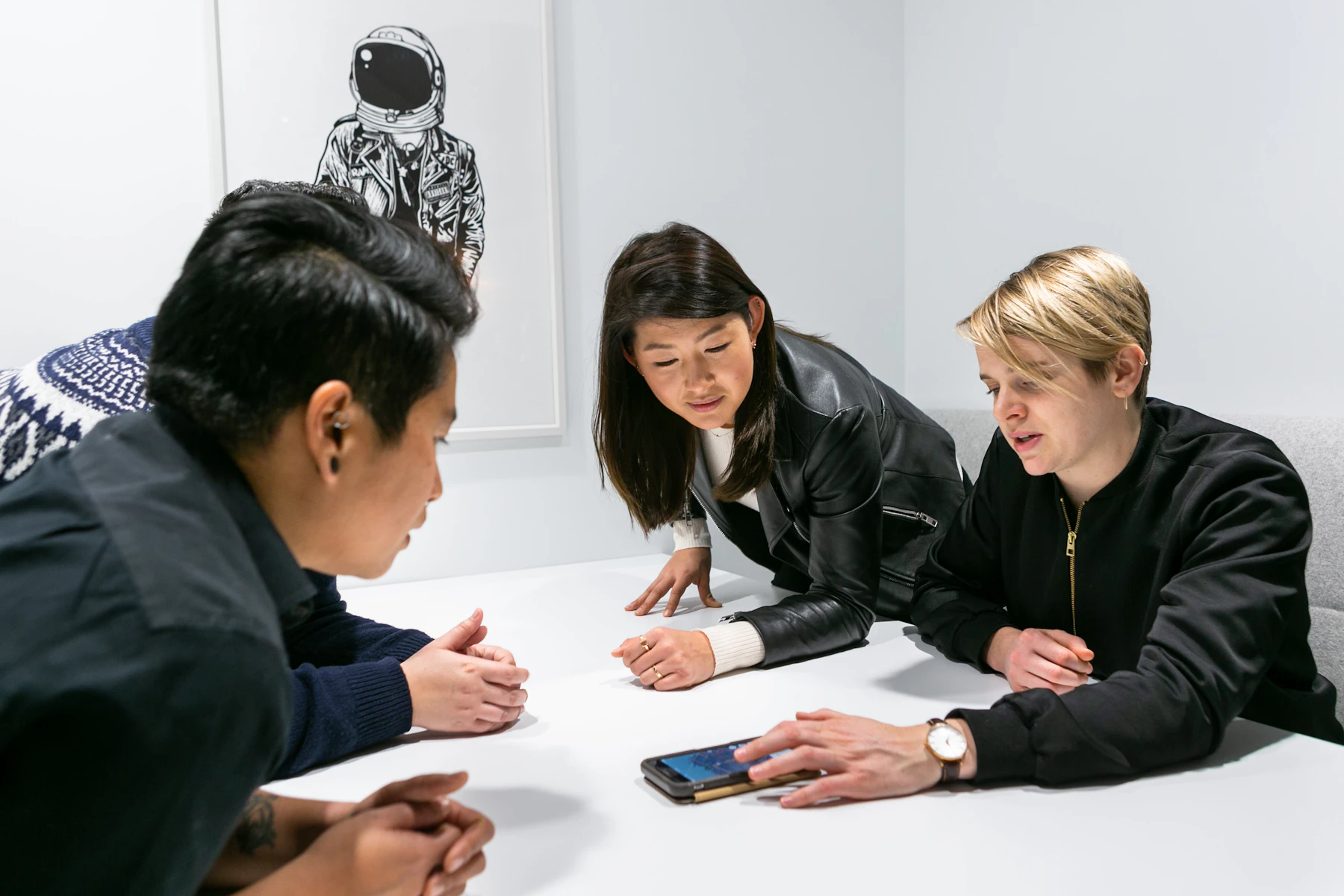A product team discussing an application around a table